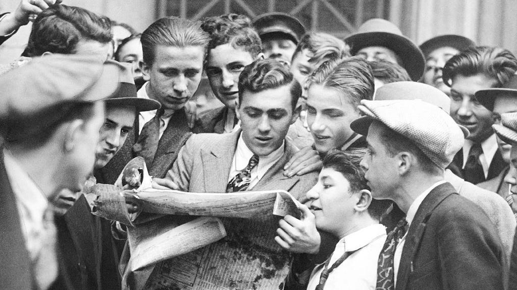 Los mensajeros de las casas de bolsa se agolpan en torno a un peri&oacute;dico tras el primer desplome de la bolsa de Wall Street el 24 de octubre de 1929.