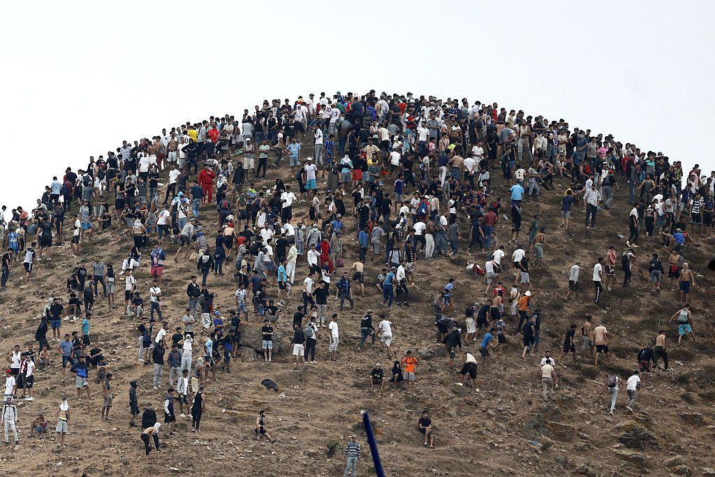 En la foto se ve a cientos de personas en un pequeño espacio tras cruzar la frontera.