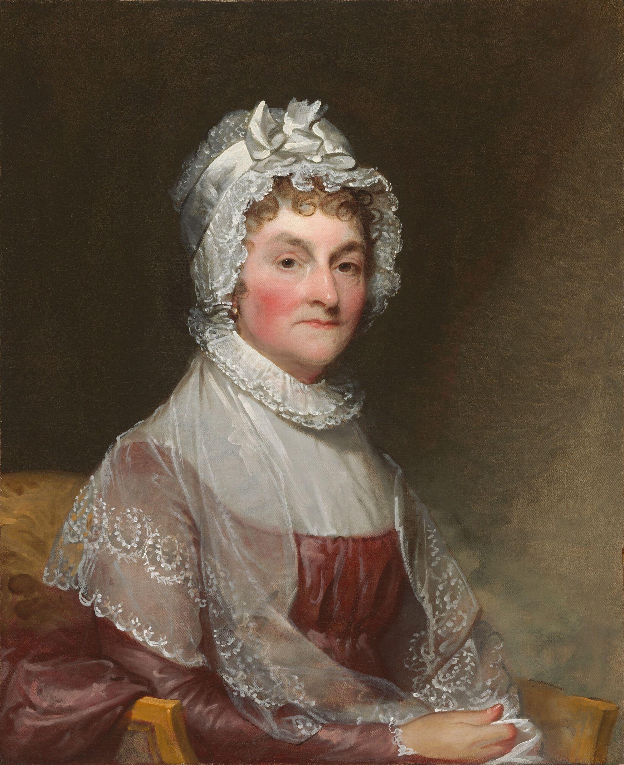 Retrato al &oacute;leo de una persona sentada con vestido y cofia de encaje, sobre un fondo oscuro.