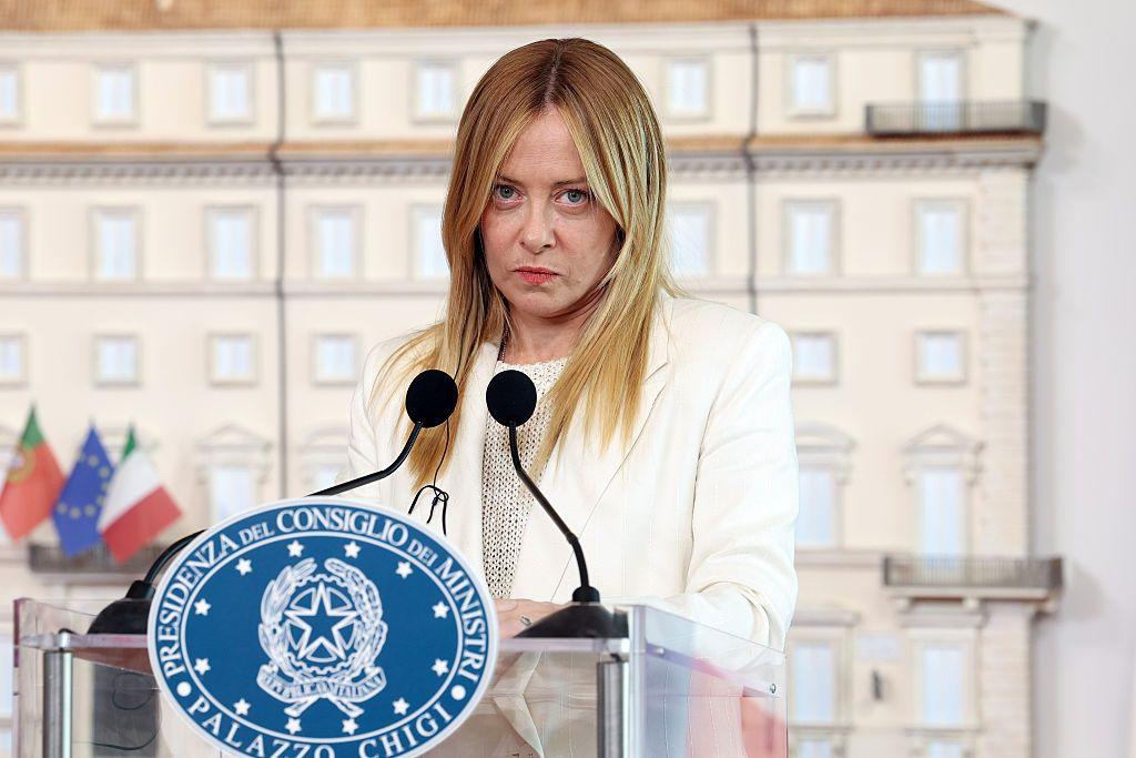 La primera ministra italiana, Giorgia Meloni, habla ante un grupo de periodistas desde un podio.