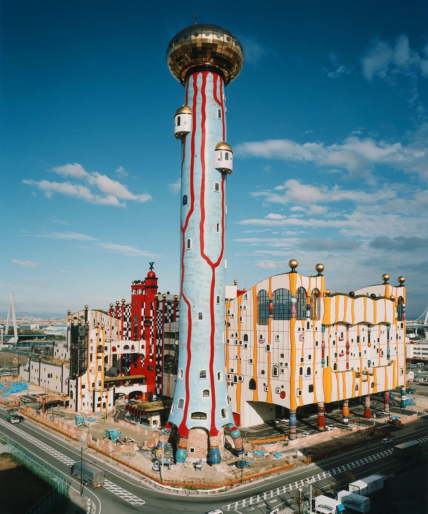 Un edificio masivo pintado de colores con una gran torre azul al frente.