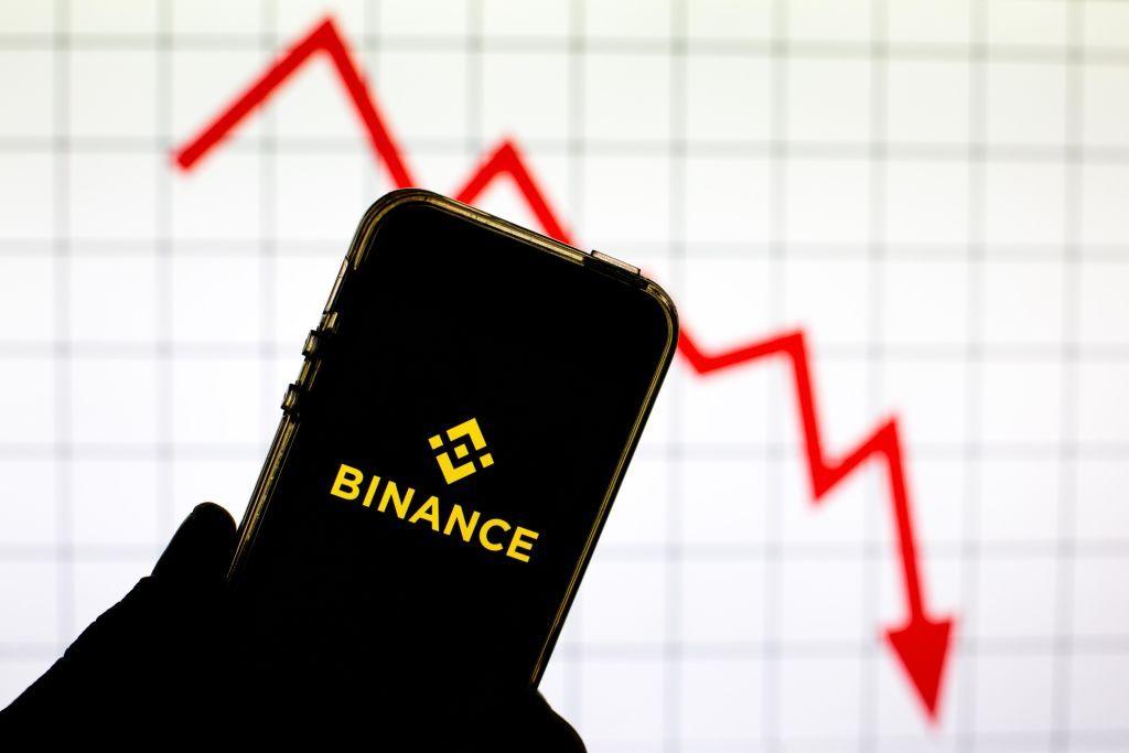Un celular con el logo de bitcoins y una flecha roja. 